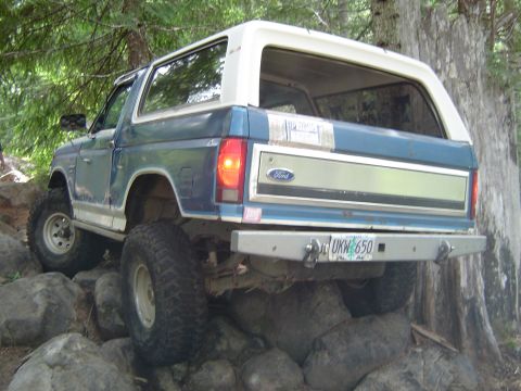 1989 Ford Bronco - Ford Bronco navigates rocky terrain during an off-road excursion.