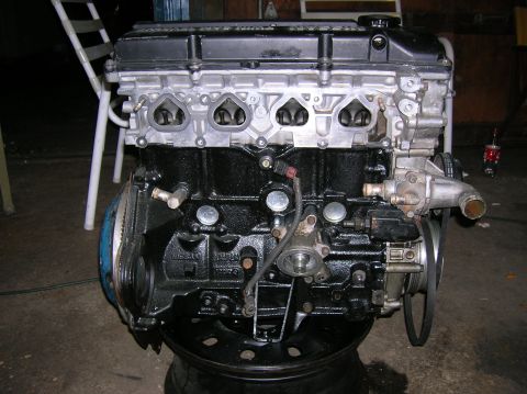 1992 Nissan 240SX - This is a close-up view of a car engine, likely out of a vehicle for repair or replacement.