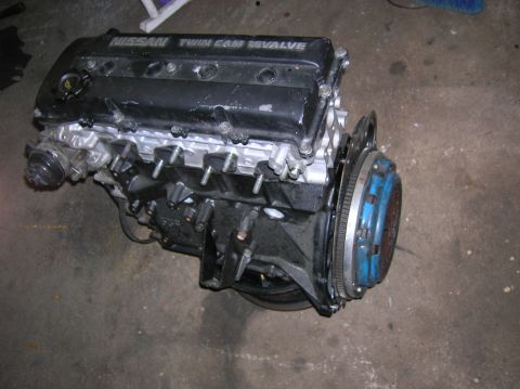 1992 Nissan 240SX - A 1992 Nissan 240SX engine is shown with its black valve cover and blue clutch assembly.