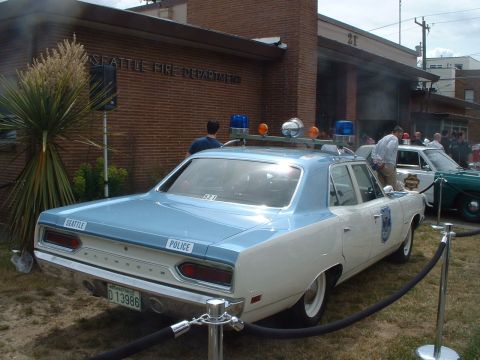 2000 Ford Crown Victoria - Seattle Police car, a 1970 Plymouth Satellite, is displayed outside the Seattle Fire Department building.