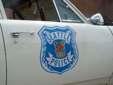 2000 Ford Crown Victoria - Close-up of a Seattle Police shield decal on the side of a white vehicle. The decal reads 'Seattle Police'.