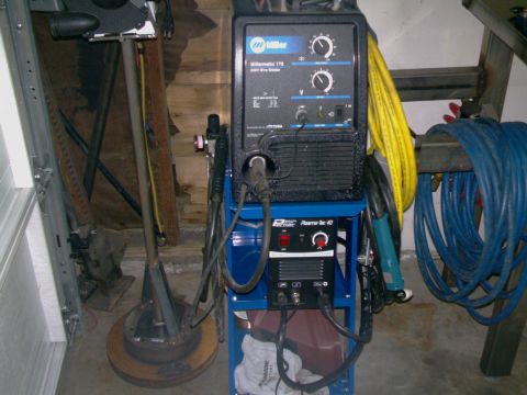1989 Ford Bronco - Welding equipment including a Miller Millermatic 175 wire welder and a Plasma-Tec 40 unit are shown on a blue cart with various cables.