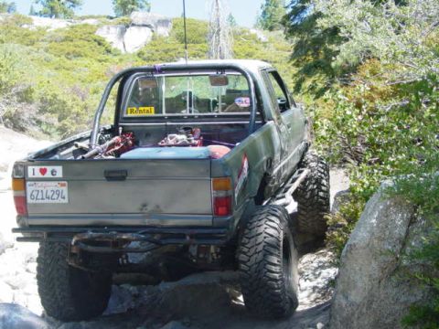 1986 Ford Bronco - This modified pickup truck navigates a challenging off-road course.