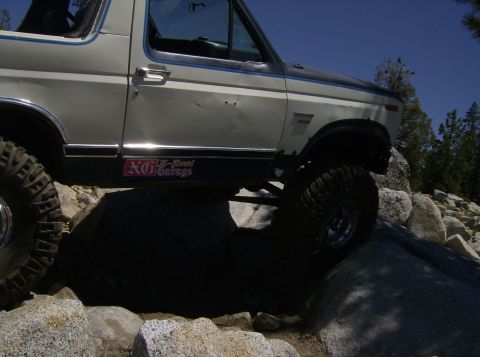 1986 Ford Bronco - This 1986 Ford Bronco navigates a rocky trail, its off-road capabilities with large tires and a two-tone paint scheme.