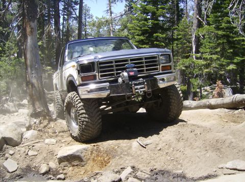 1986 Ford Bronco - This modified Ford Bronco navigates a challenging off-road course through a wooded area.