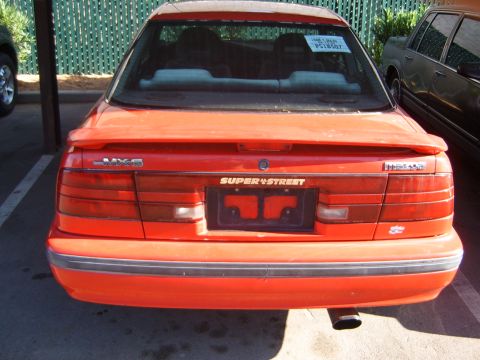 2001 Pontiac Trans Am - Rear view of a red Mazda MX-6, a "SUPER+STREET" plate frame and a spoiler.