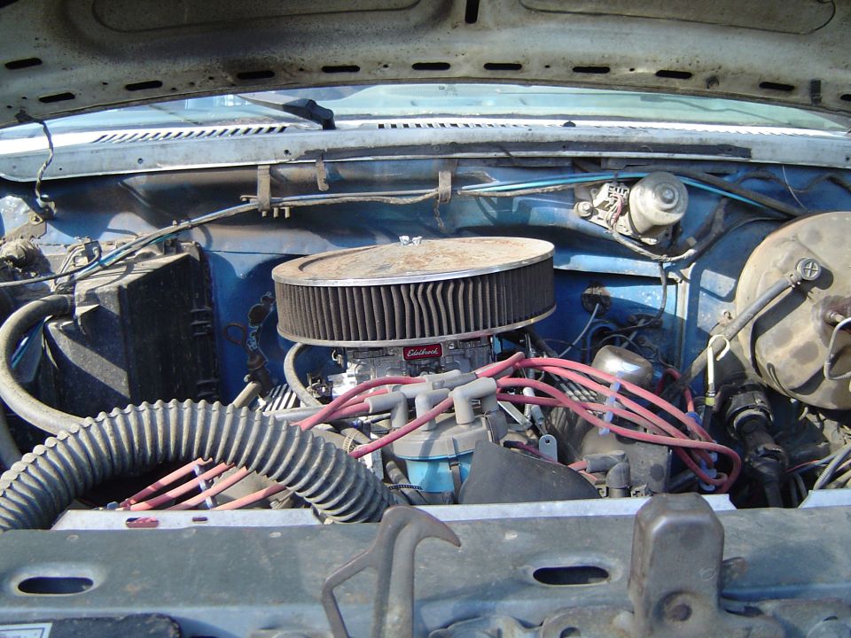 Engine bay with chrome air cleaner and red spark plug wires