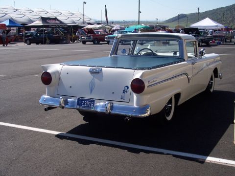1972 Ford Ranchero - A classic white Ford Ranchero with a blue tonneau cover is parked at an outdoor event.