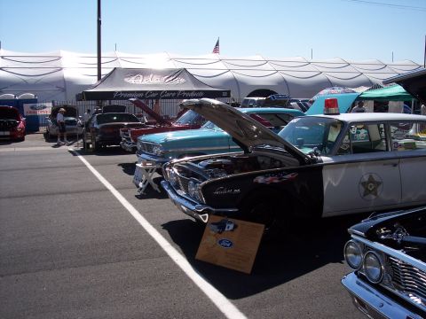 1972 Ford Ranchero - A vintage police car, possibly a 1960 model, is displayed with its hood open at an outdoor car event.