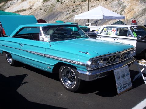 1972 Ford Ranchero - A turquoise 1963 Ford Galaxie 500 is displayed at an outdoor event, with a police car visible behind it.