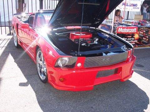 1972 Ford Ranchero - Red convertible with engine exposed, a custom front end and chrome wheels.