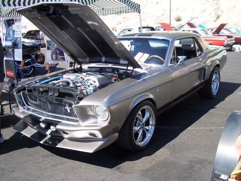 1972 Ford Ranchero - A classic Ford Mustang is displayed with its hood up, revealing the engine bay.