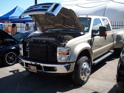 1972 Ford Ranchero - A tan Ford F-350 Super Duty pickup truck is displayed with its hood open at an outdoor event.