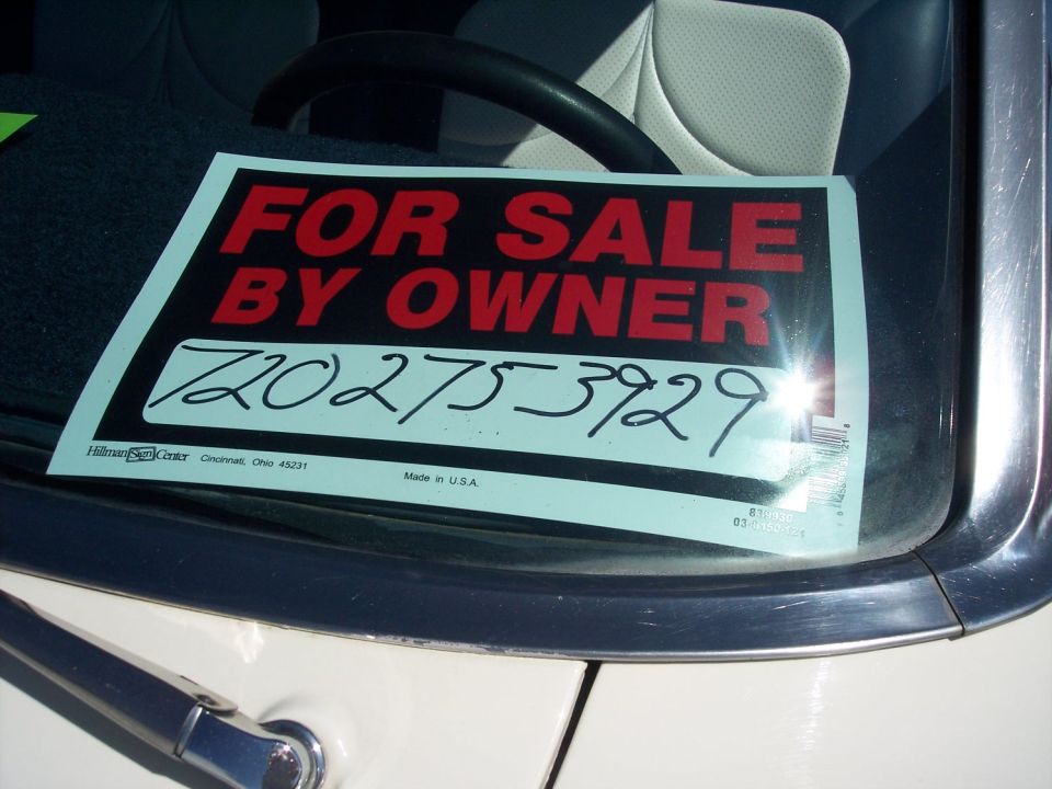 For Sale By Owner sign with phone number 720-275-3929 on windshield