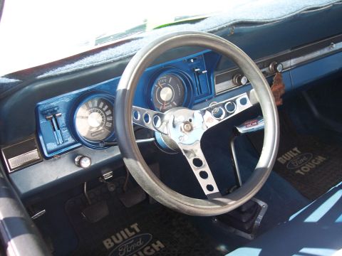 1972 Ford Ranchero - Interior view of a 1972 Ford Ranchero, an aftermarket steering wheel and "Built Ford Tough" floor mats.