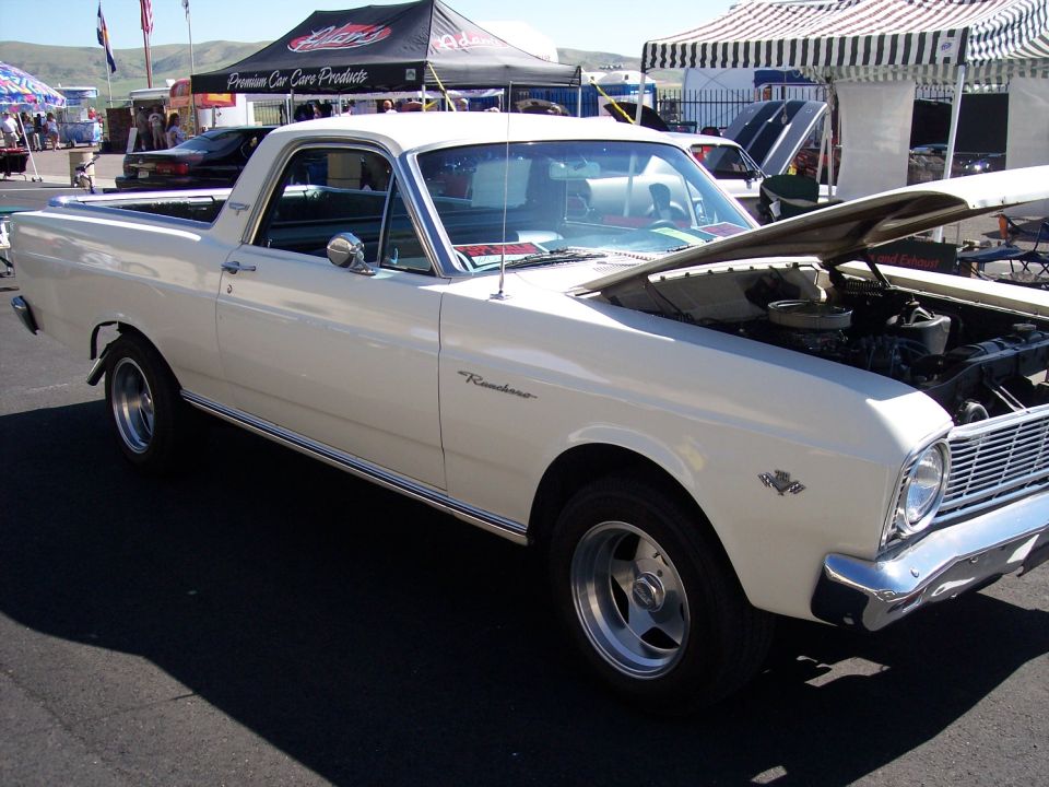 White 1966 Ford Ranchero with hood open, chrome trim, and aftermarket wheels