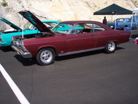 1972 Ford Ranchero - A maroon 1966 Ford Fairlane 500 coupe is displayed at an outdoor car show, with its hood up, alongside other vehicles.