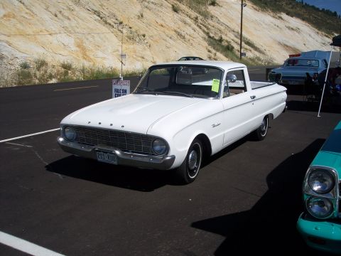 1972 Ford Ranchero - White 1960 Ford Falcon Ranchero parked at an outdoor event, with another vehicle partially visible.