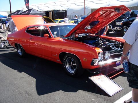 1972 Ford Ranchero - An orange 1970 Ford Ranchero is displayed with its hood open at an outdoor event.