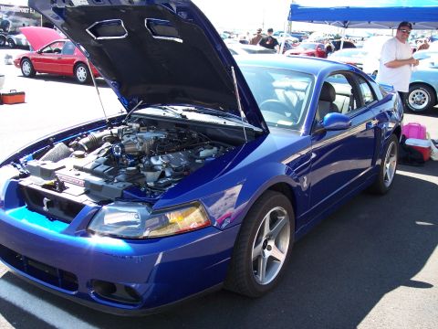 1972 Ford Ranchero - A blue Ford Mustang is parked with its hood open, revealing the engine compartment.
