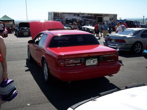1972 Ford Ranchero - A red Mercury Cougar XR7 is parked with its hood open at an outdoor event.
