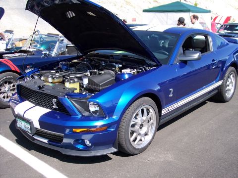 1972 Ford Ranchero - A blue Ford Mustang Shelby GT500 is displayed with its hood open, revealing the engine compartment.