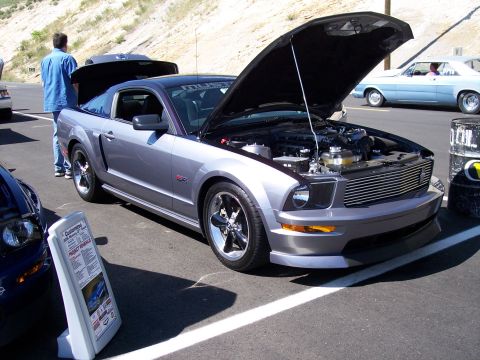 1972 Ford Ranchero - A silver Ford Mustang GT coupe is displayed with its hood open, revealing the engine bay.