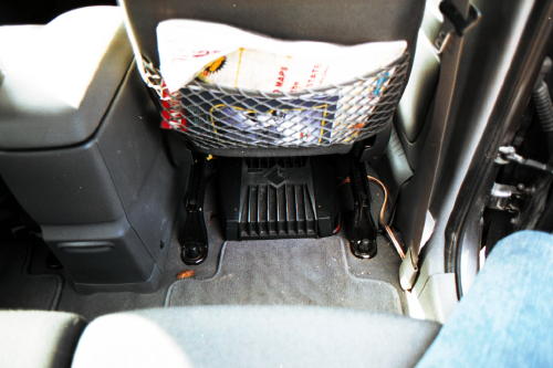 The amp is under the passanger seat up front.  I made little stilts for it so when the floor heat is on, the heat travels under it to the rear passangers feet!