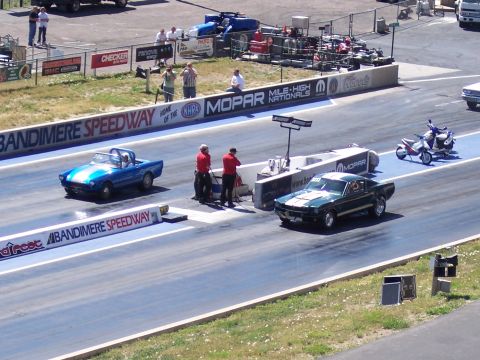 1972 Ford Ranchero - Two cars and a scooter at Bandimere Speedway during a drag race event.