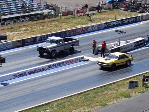 1972 Ford Ranchero - A yellow coupe races down the drag strip at Bandimere Speedway.