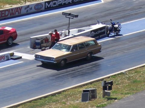 1972 Ford Ranchero - A gold station wagon is on the drag strip, with the number 015 visible on its windshield.