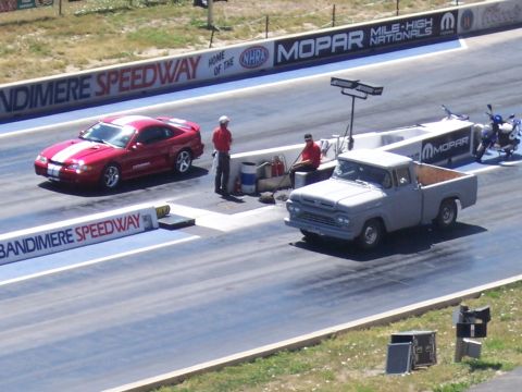 1972 Ford Ranchero - A gray 1959 Ford pickup and a red Ford Mustang are lined up on the drag strip at Bandimere Speedway.