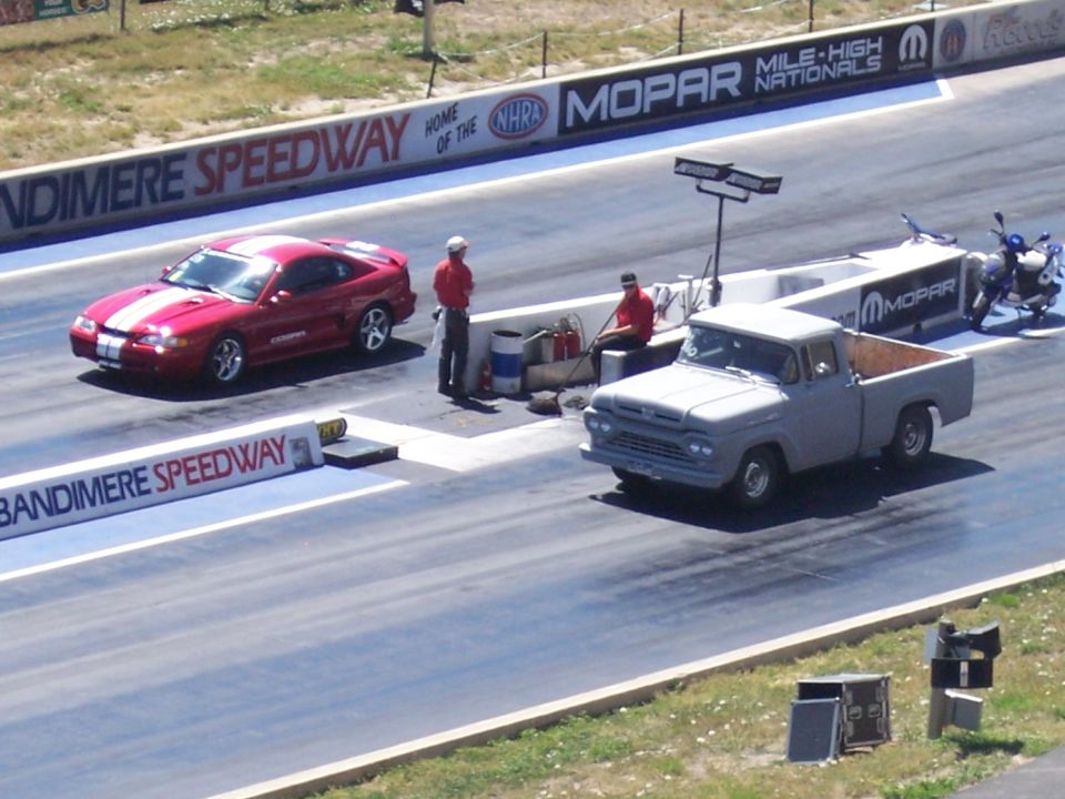 Gray 1959 Ford F-series pickup and red Ford Mustang on Bandimere Speedway drag strip