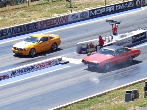1972 Ford Ranchero - Two cars compete on a drag strip, with the red car appearing to be a 1969 Ford Torino.