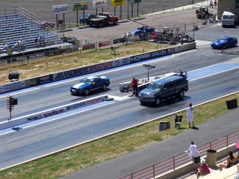 1972 Ford Ranchero - Vehicles compete on the drag strip at Bandimere Speedway, with spectators in the stands.