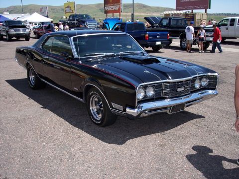 1972 Ford Ranchero - Black 1970 Mercury Cyclone Spoiler with a hood scoop parked at Bandimere Speedway.