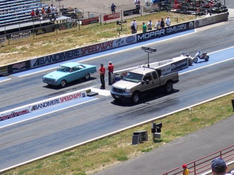 1972 Ford Ranchero - A light blue 1963 Ford Falcon sedan is lined up on a drag strip next to a pickup truck.