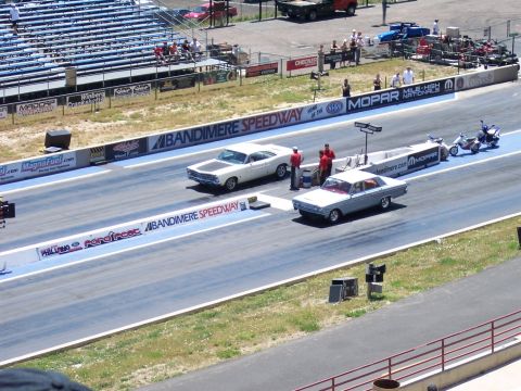 1972 Ford Ranchero - Drag racing event at Bandimere Speedway with multiple vehicles on the track and motorcycles in the background.