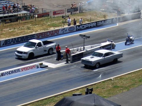 1972 Ford Ranchero - Two cars and a motorcycle at Bandimere Speedway during a drag race event.
