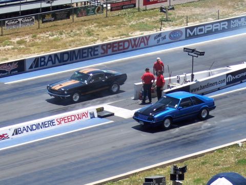 1972 Ford Ranchero - Cars line up for a drag race at Bandimere Speedway, with officials watching from the side.