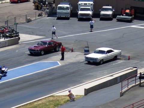 1972 Ford Ranchero - A drag race is about to begin with two classic cars lined up on the track.