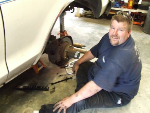 1979 Ford Bronco - Working on the front brake assembly of a 1979 Ford Bronco, which is supported by jack stands.