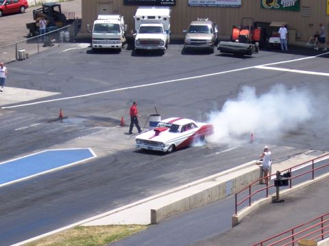 1972 Ford Ranchero - A 1964 Ford Falcon performs a burnout on a drag strip, kicking up a large cloud of smoke.