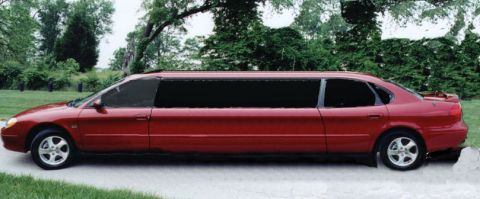 1991 Ford Taurus - Side view of a red 1991 Ford Taurus limousine.