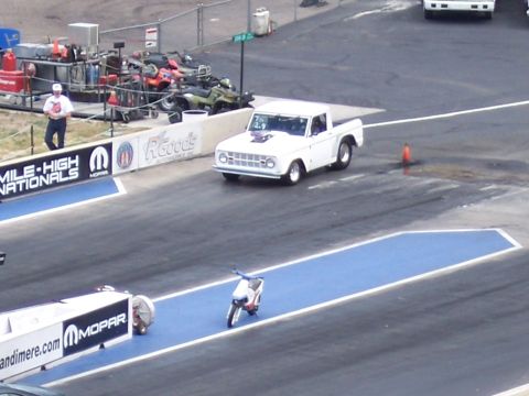 1972 Ford Ranchero - White 1968 Ford Bronco pickup truck with hood scoop on a drag strip.