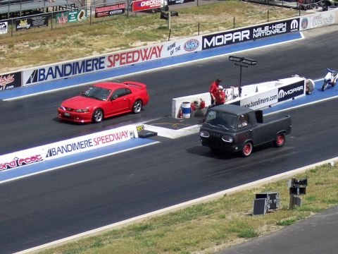 1972 Ford Ranchero - Two vehicles compete on the drag strip at Bandimere Speedway, with Mopar and NHRA banners visible.