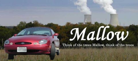 1991 Ford Taurus - Red sedan in a field with a power plant in the distance.