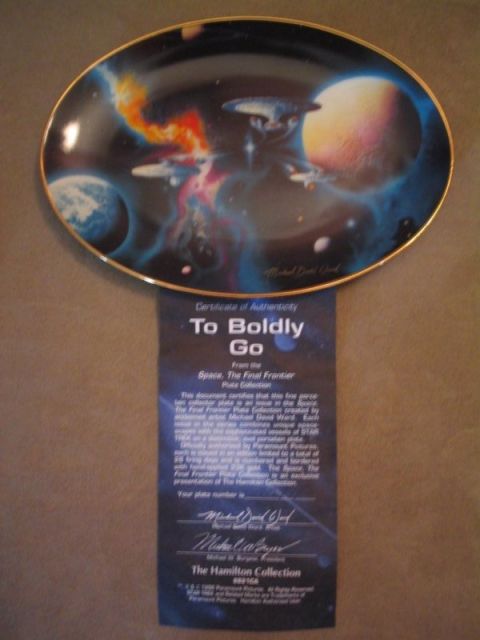 1998 Ford Crown Victoria - A decorative plate and its certificate of authenticity are displayed against a textured background.