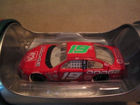1998 Ford Crown Victoria - A red Dodge race car, number 19, is displayed inside its packaging.