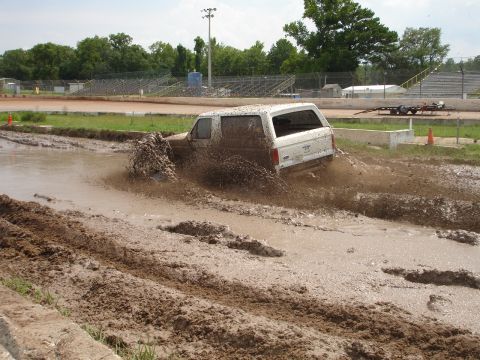 1989 Ford Bronco - A white 1987 Ford Bronco navigates a muddy track at Putnam Speedway on June 24, 2007.